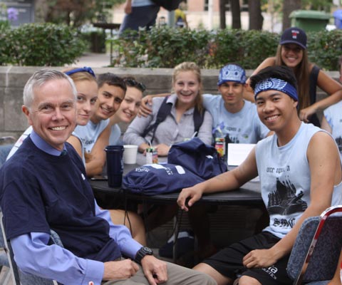 A group of students siting outside of university