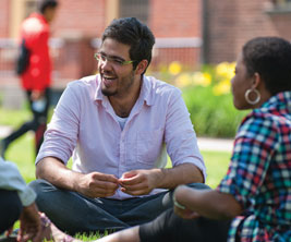 Students siting in university garden and discussing each other