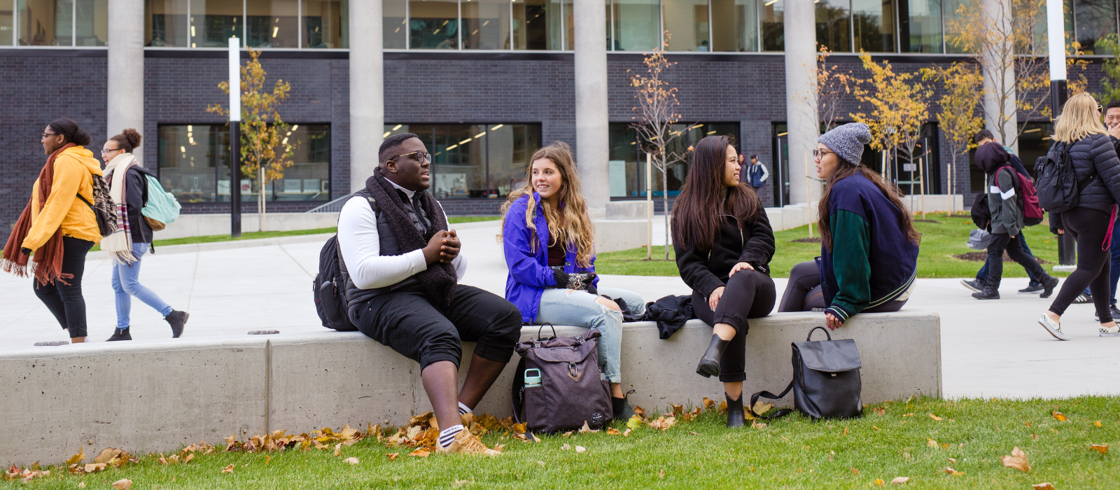 Students sitting and chatting outside on a campus